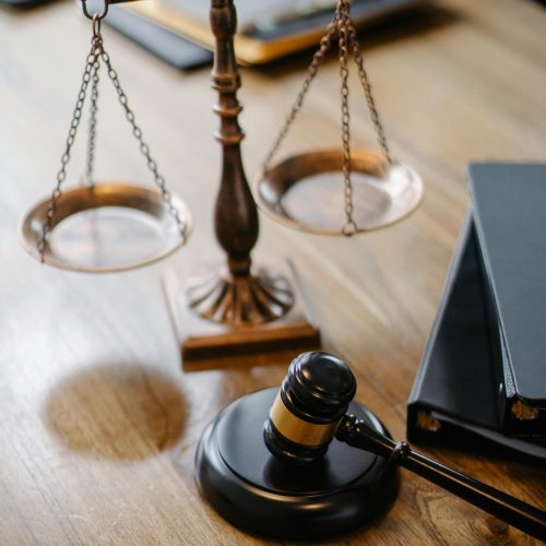 High angle lawyers desk with decorative judgement scales and gavel in modern law firm
